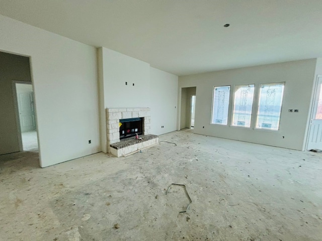 unfurnished living room with a stone fireplace