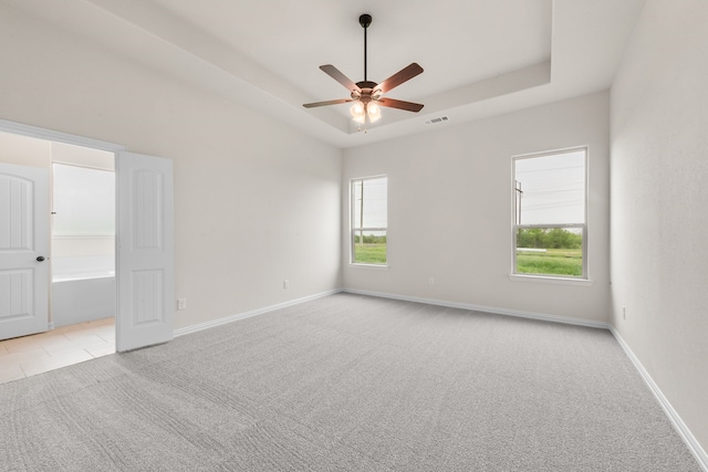 120 Roosevelt Ln, Valley View, TX 76272 - unfurnished room featuring a ceiling fan, a healthy amount of sunlight, a raised ceiling, light colored carpet, and visible vents