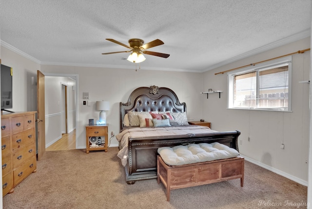 bedroom featuring ceiling fan, a textured ceiling, light carpet, and ornamental molding