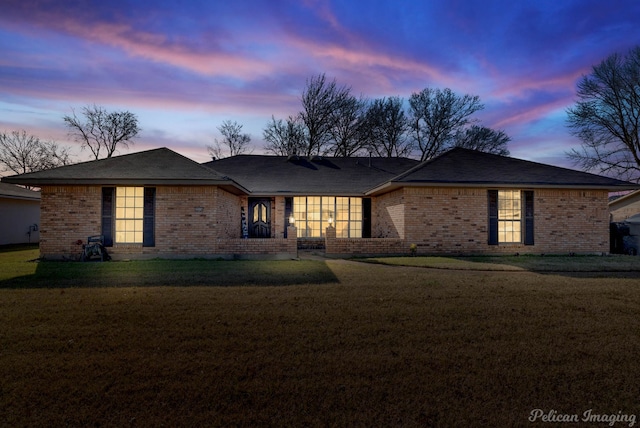 ranch-style house featuring a yard