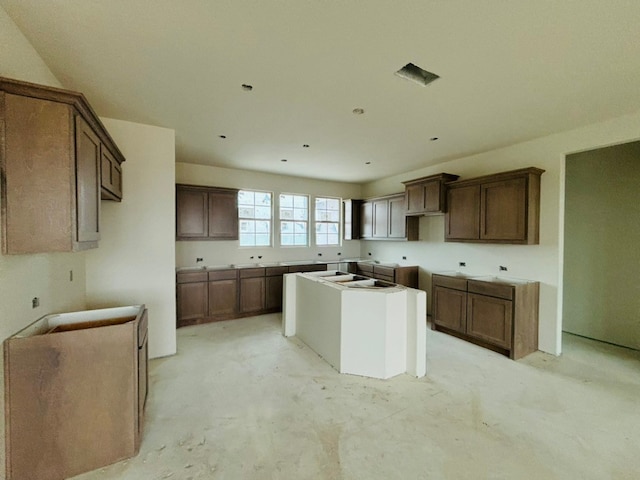 kitchen with dark brown cabinetry and a center island