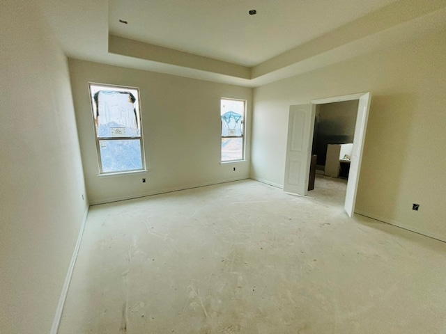 unfurnished bedroom featuring a tray ceiling