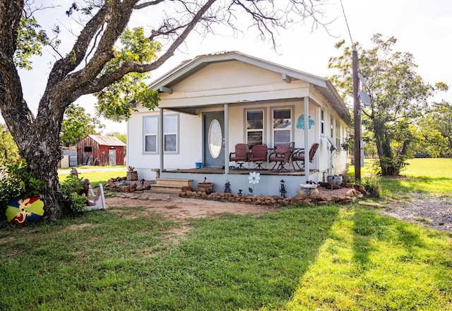 bungalow-style house with a front yard and a porch