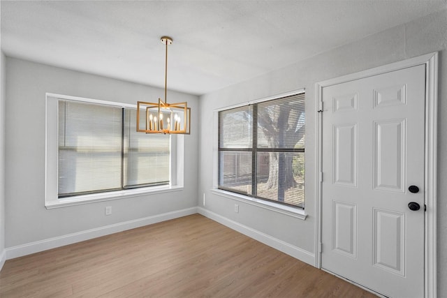 interior space featuring a chandelier and light hardwood / wood-style flooring