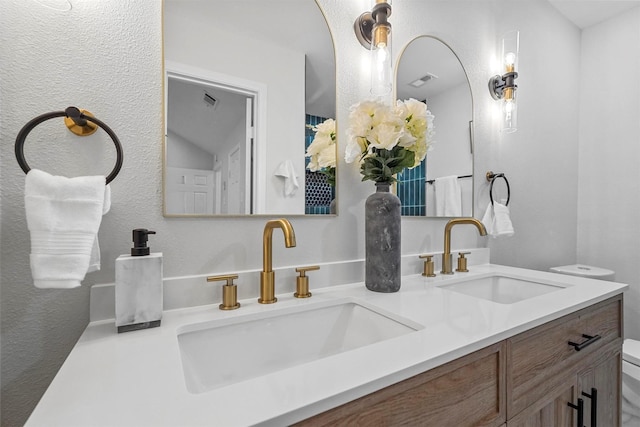 bathroom featuring toilet and vanity