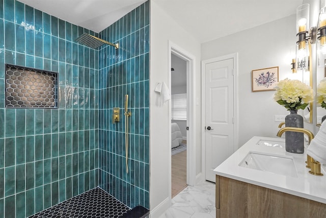 bathroom featuring vanity and tiled shower