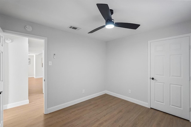 unfurnished bedroom featuring ceiling fan and hardwood / wood-style flooring