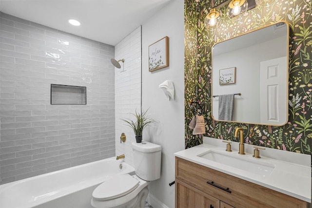 full bathroom featuring tiled shower / bath combo, vanity, and toilet