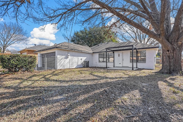 single story home with a pergola, a patio area, central air condition unit, and a sunroom