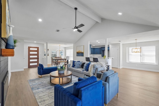 living room featuring beam ceiling, high vaulted ceiling, ceiling fan with notable chandelier, and light hardwood / wood-style flooring