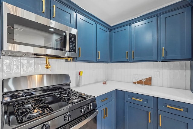 kitchen featuring backsplash, gas stove, and blue cabinets