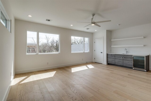 5808 Brookstown Dr, Dallas, TX 75230 - unfurnished bedroom featuring beverage cooler, wet bar, light wood finished floors, baseboards, and recessed lighting