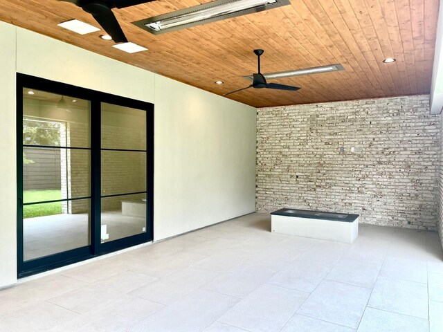 5808 Brookstown Dr, Dallas, TX 75230 - tiled empty room featuring wooden ceiling, brick wall, and a ceiling fan