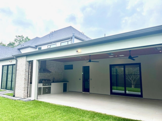 5808 Brookstown Dr, Dallas, TX 75230 - back of property featuring ceiling fan, an outdoor kitchen, a patio area, a yard, and stucco siding