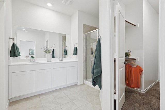 bathroom with tile patterned floors, walk in shower, and vanity