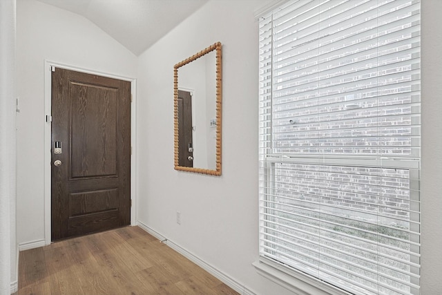 interior space featuring vaulted ceiling and light hardwood / wood-style floors