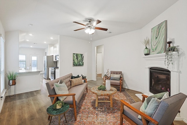 living room featuring hardwood / wood-style flooring and ceiling fan