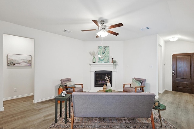 living room with hardwood / wood-style flooring and ceiling fan