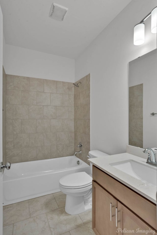 full bathroom with toilet, vanity, tiled shower / bath, and tile patterned flooring