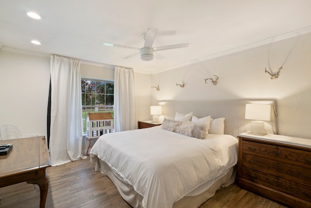 bedroom featuring ceiling fan, wood-type flooring, and crown molding