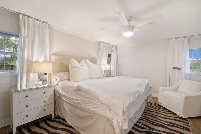 bedroom with ceiling fan and dark hardwood / wood-style floors