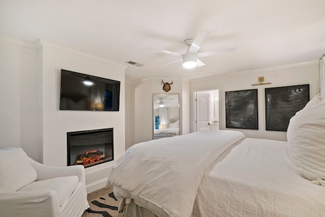 bedroom with ceiling fan, crown molding, and hardwood / wood-style floors