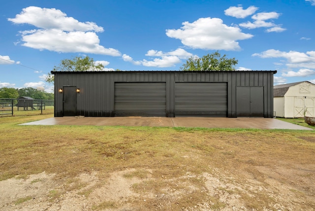 view of outbuilding with a garage and a lawn