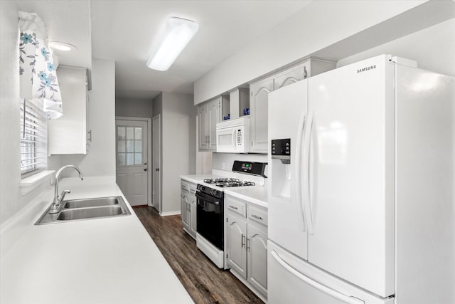 kitchen featuring dark wood-type flooring, sink, white cabinets, and white appliances