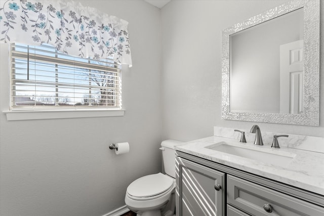 bathroom featuring toilet and vanity