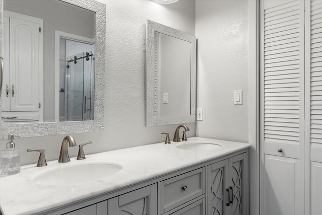 bathroom with walk in shower and vanity