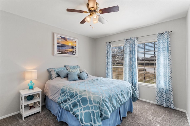 bedroom with ceiling fan, carpet floors, and multiple windows