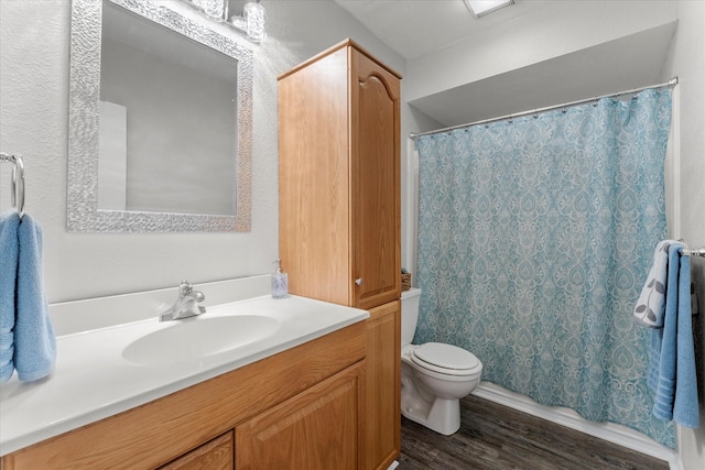 bathroom featuring toilet, a shower with shower curtain, wood-type flooring, and vanity