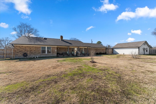 rear view of property featuring a yard