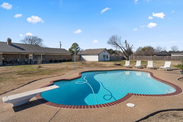 view of swimming pool featuring an outdoor structure, a yard, a diving board, and a patio