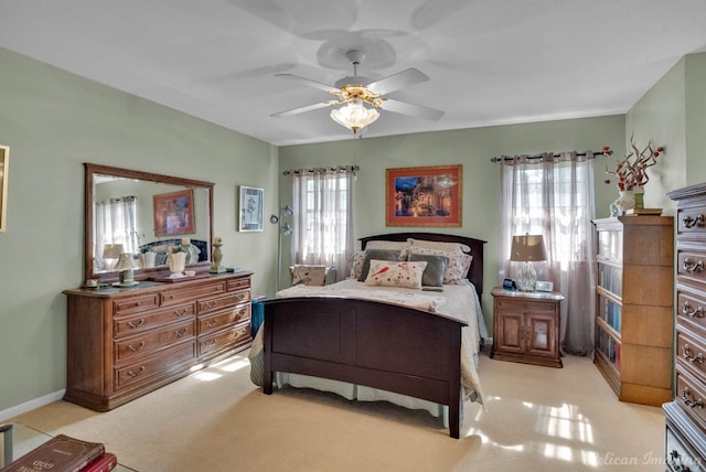 bedroom featuring ceiling fan and light carpet