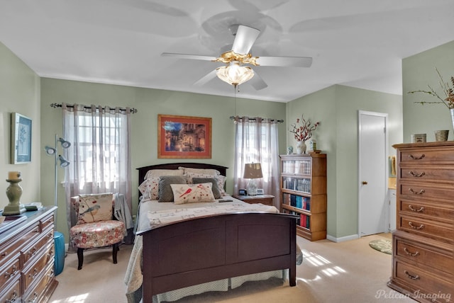 bedroom with ceiling fan and light colored carpet