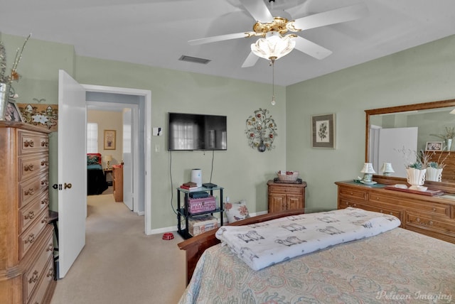 bedroom with ceiling fan and light colored carpet