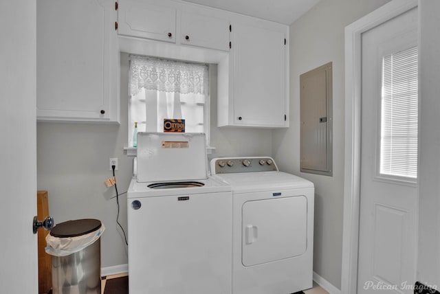 laundry area with cabinets, washer and clothes dryer, and electric panel