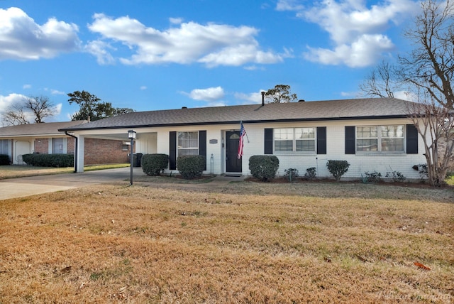 ranch-style house with a front yard and a carport