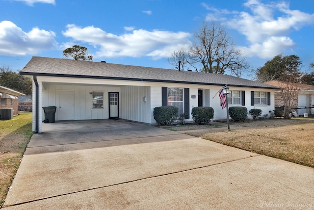 ranch-style house featuring central AC unit, a front lawn, and a carport