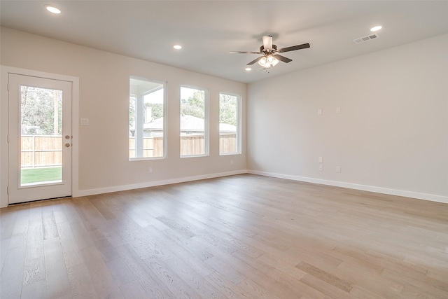 unfurnished room with plenty of natural light, light hardwood / wood-style floors, and ceiling fan