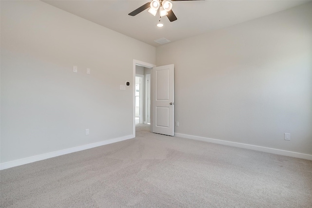 unfurnished room featuring light colored carpet and ceiling fan