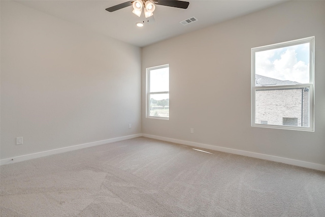 unfurnished room featuring ceiling fan and carpet