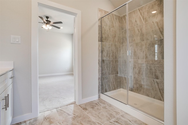 bathroom featuring vanity, a shower with door, and ceiling fan