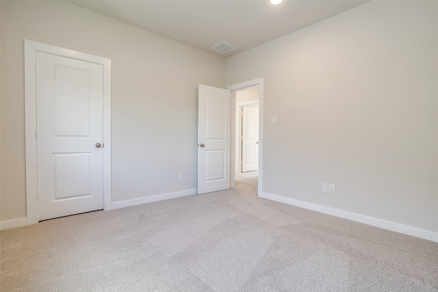 unfurnished room with light colored carpet