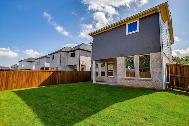 rear view of property featuring a yard