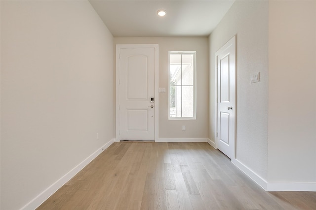 foyer entrance with light hardwood / wood-style floors