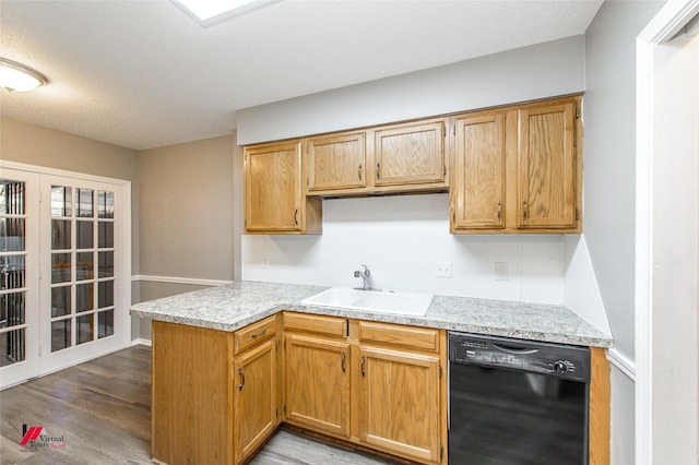 kitchen with sink, hardwood / wood-style floors, dishwasher, and kitchen peninsula