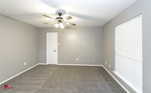 spare room with ceiling fan and carpet