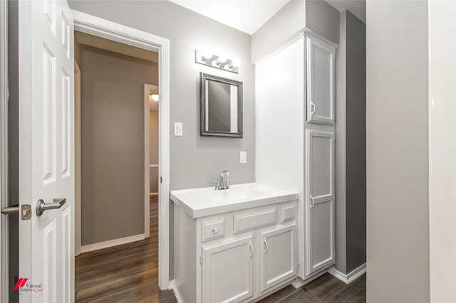 bathroom with hardwood / wood-style floors and vanity